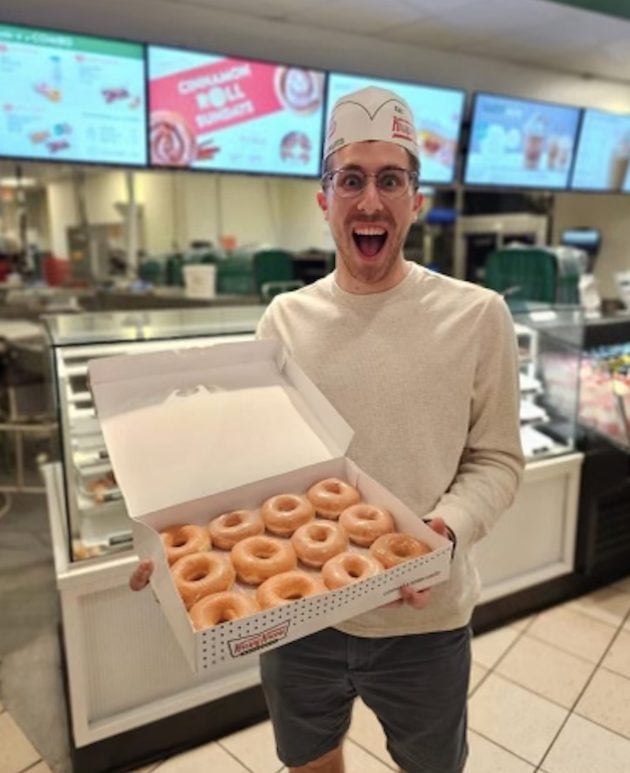 Holding Krispy Kreme doughnuts